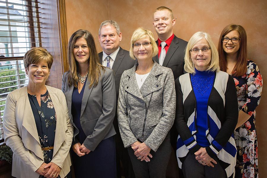 About Our Agency - Group Photo of Everett Schmenk Insurance Agency, Featuring Seven Team Members Nicely Dressed and Standing Together in Their Office
