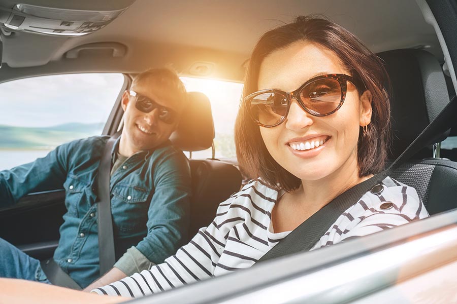 Contact - Young Couple Wearing Sunglasses Smile and Set Off on a Road Trip, Seatbelts Buckled