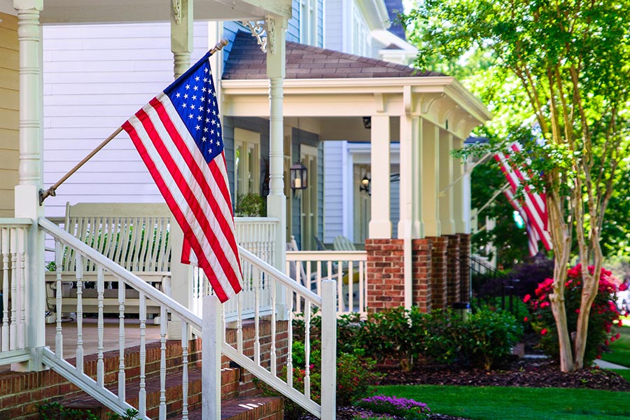 Kalida, OH Insurance - American Flags on Front Porches, Green Grass and Flower Beds Between Them